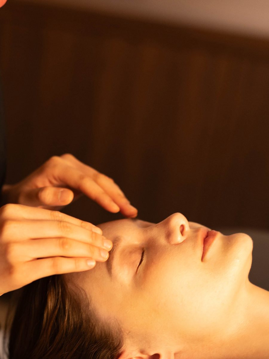 Hands working across the brow during the 120 minute Advanced Face and Body Sculpt treatment